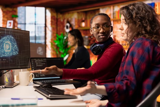 Startup software developers doing brainstorming to do rapid technological advancement in AI industry. African american woman and coworker leveraging machine learning tech to gain competitive edge photo