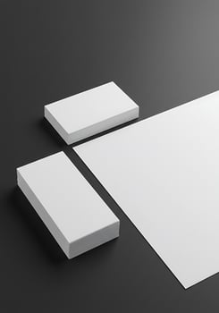 Blank white paper and business card mockup on black background photo