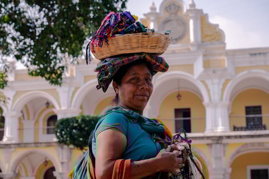 Indigenous Guatemalan woman selling crafts in Antigua with traditional dress photo