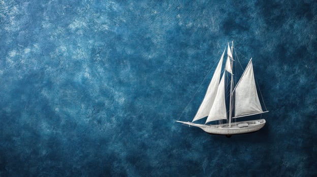 Model sailboat on blue textured background photo