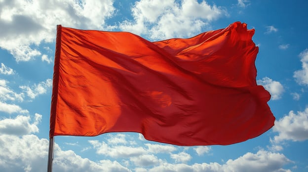 A red flag flying in the wind photo