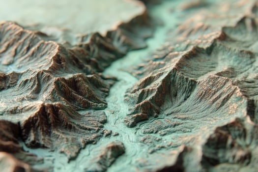 Intricate close-up of a textured 3D terrain model showcasing winding valleys and rugged mountainous landscape in earthy brown and green hues, emphasizing geological features and elevation photo