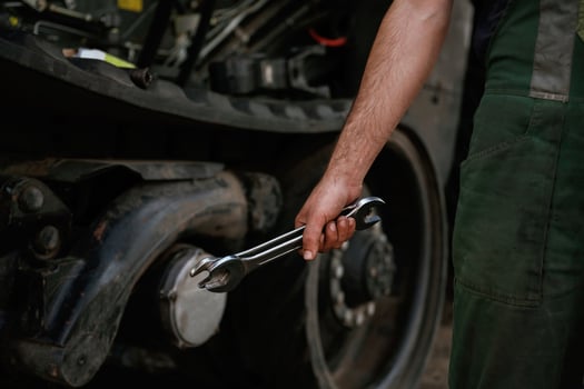 Holding wrench. Mechanic's ,hand fixing machinery in workshop photo