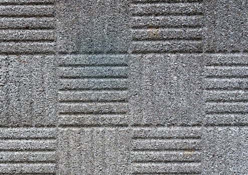 Close-up of patterned concrete texture with grooves and rough surface. photo
