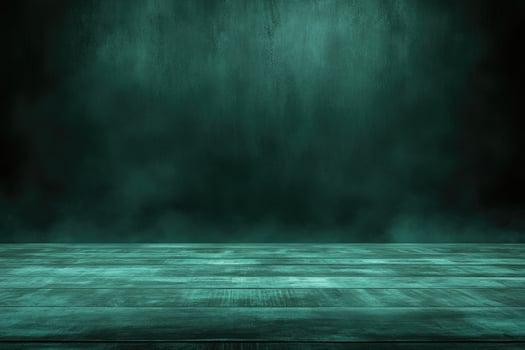 An empty room with a green wall and wooden floor photo