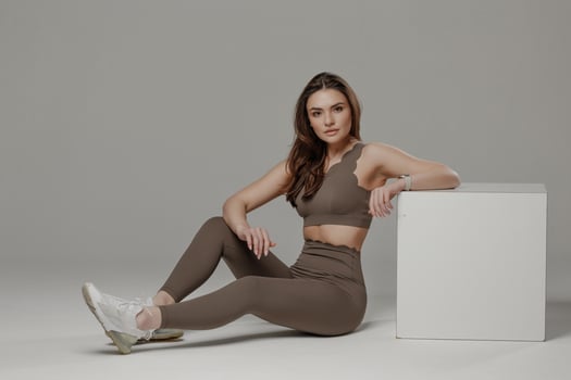 Model poses in stylish activewear against a neutral background showcasing fitness and fashion photo