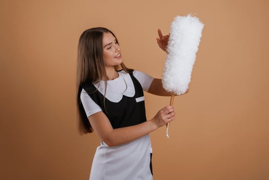 Occupation of chambermaid,.. Young pretty woman is against background in the studio photo