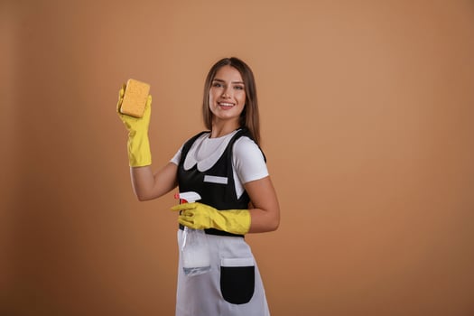 Against ,,background, chambermaid at work. Young pretty woman is in the studio photo