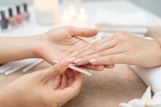Woman receive care service by professional Beautician Manicure at spa centre. Nail beauty salon use nail file for Glazing treatment. manicurist make nail customer to beautiful. body care spa photo