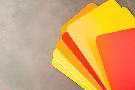 A pile of yellow, orange, and red cards photo