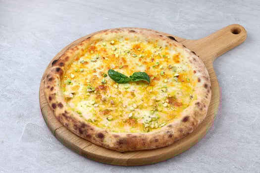 Neapolitan Four Cheese Pizza with Honey Pistachios on Wooden Board photo