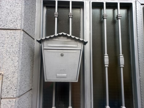 Classic metal mailbox on residential gate for security and style photo