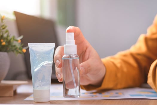 Alcohol sanitize to clean up her hands to kill and protect from bacteria and coronavirus photo