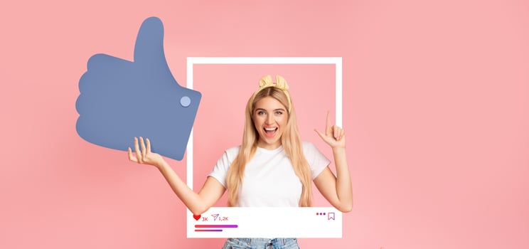 A young influencer joyfully poses against a pink background, holding a large thumbs up symbol. She showcases excitement while interacting with her online audience, promoting positivity and engagement. photo