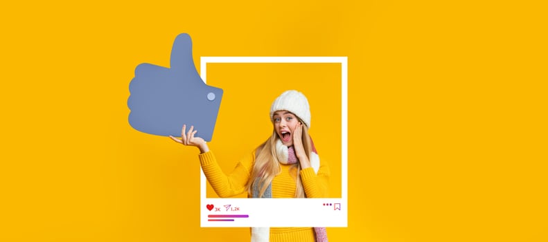 A young woman expressing excitement with a thumbs-up gesture. She wears a cozy yellow sweater and a warm hat, surrounded by a bright yellow background that enhances her joyful expression. photo