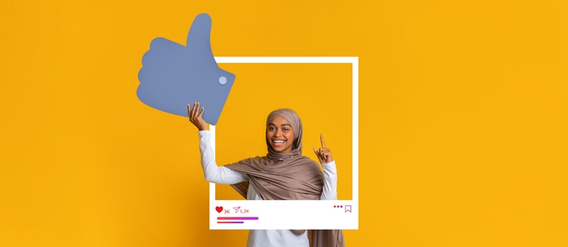 A happy individual showcases a thumbs up gesture inside a social media frame. photo