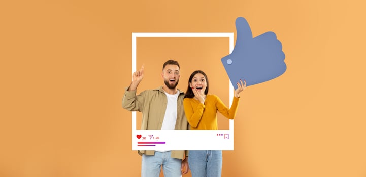 A happy couple poses in front of a warm orange background, celebrating social media interaction. They enthusiastically display thumbs up, embodying positive influencer culture. photo