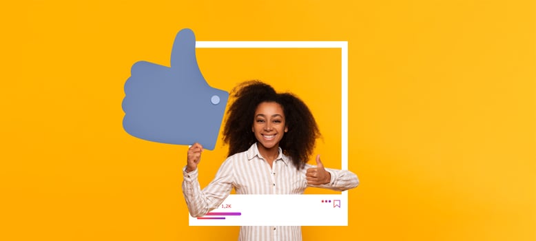 A young girl smiles while holding a large thumbs up symbol in front of a vivid yellow background. She is promoting positive interaction on social media and celebrating her influence. photo