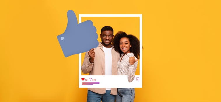 A young couple stands smiling in front of a bright yellow background, showcasing a playful thumbs-up gesture. They appear to celebrate their social media success as influencers. photo