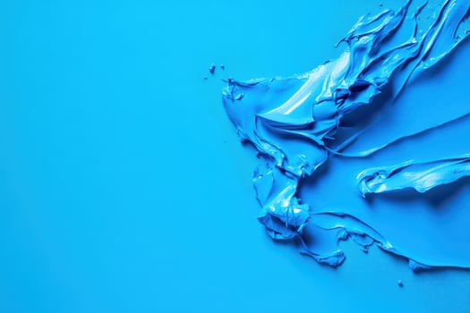 Creative blue paint swirl on a vibrant background photo