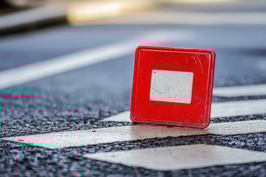 Red warning sign on crosswalk in city area photo