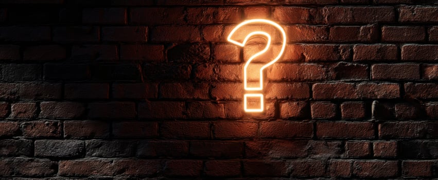 The Glowing Question Mark Against a Rustic Brick Wall photo