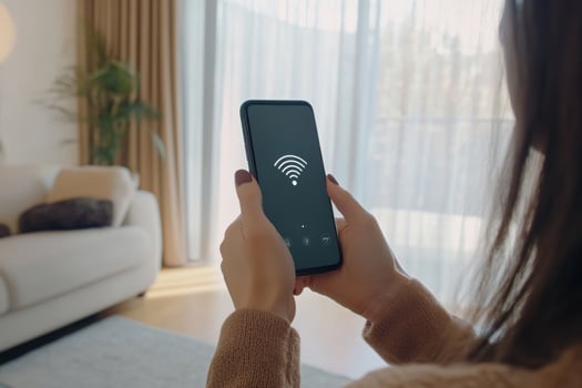 Woman checking WiFi connection on smartphone while seated in cozy indoor environment with natural light photo