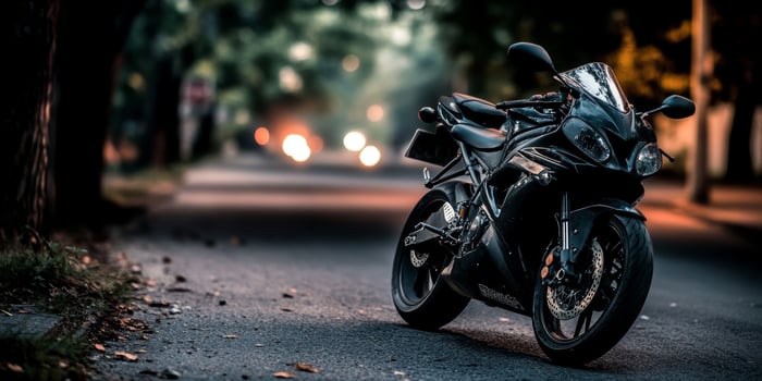 Sport motorcycle parked on a quiet street during twilight with warm bokeh lights in the background photo