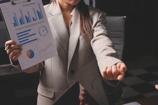A businesswoman is holding a clipboard with a graph on it photo