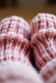 close up of a pair of pink knitted mittens photo