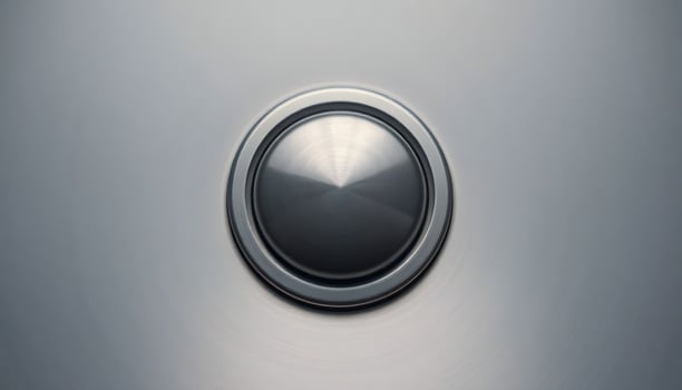 close up of a button on a metal surface photo