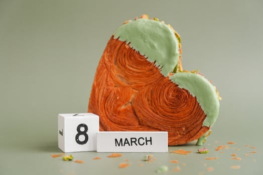8 march Woman's day Delightful and vibrant heartshaped pastry croissant treat, beautifully topped with colorful frosting nut galore. Mock up template copy space. Food experimentation viral dessert creative baking trend photo