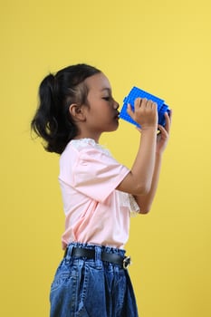 Asian Girl Kids Drink Water from Blue Cute Cup, Side View photo
