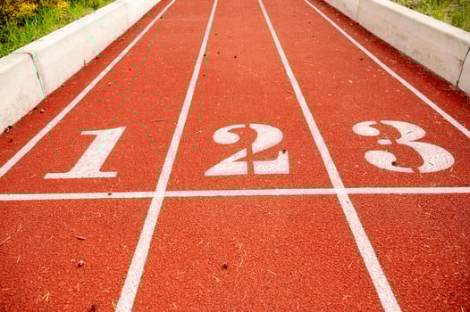 Red running track in stadium,with numbers at the start. Sport recreation. Helthy lifestyle concept. High quality photo