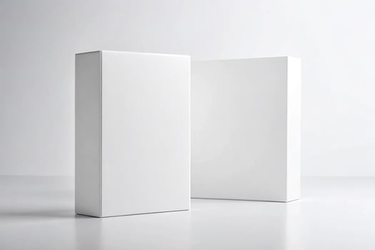 Two blank white software boxes standing upright on a white surface against a white background - Minimalist Packaging Concept photo