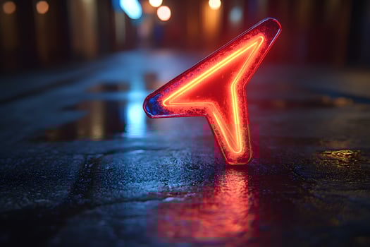 Neon Arrow Navigation Symbol on Wet Urban Street at Night photo