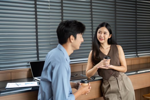 Business Conversation and Collaboration. Young professionals sharing ideas over coffee in a modern office. photo
