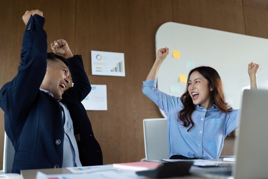 Team Excitement and Achievement. Professionals celebrating success in a modern office environment. photo
