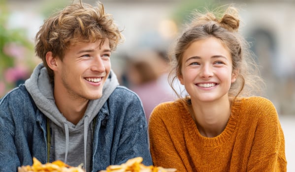 A Happy Young Couple Smiling Joyfully Together. This image evokes feelings of youth, love, and friendship, capturing a moment of p photo