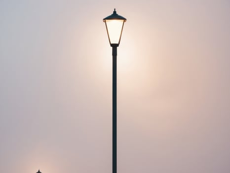 Serene Evening Light. A Lamp Post Illuminates the Tranquil Dusk, Soft Hues. photo