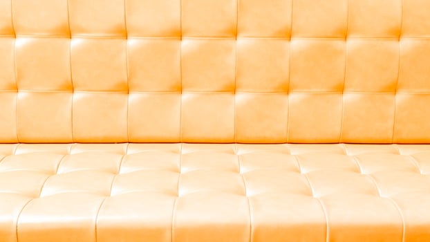 A close up of a couch with a yellow leather seat photo