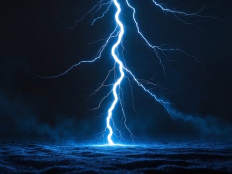 Lightning bolt striking the ground in the dark photo