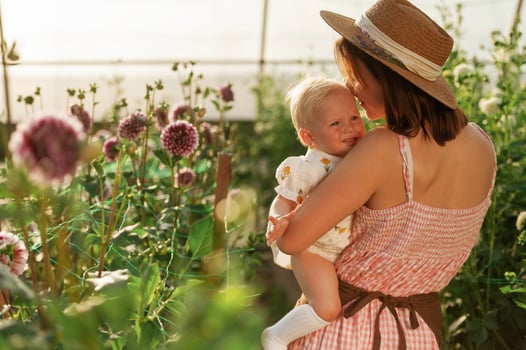 Cute baby in hands. Mother and ,daughter are in the greenhouse photo