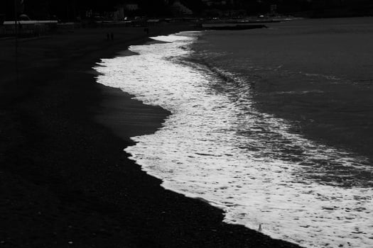 the beach with dark colors, from the white of the sea to the beach photo