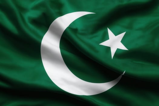 A green flag waving with a white crescent moon and star, symbolizing cultural or national identity and heritage. photo