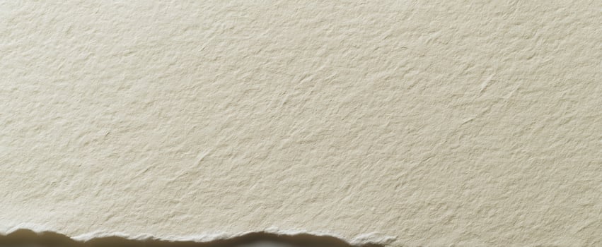 The textured surface of handmade paper with a rough edge for design inspiration. photo