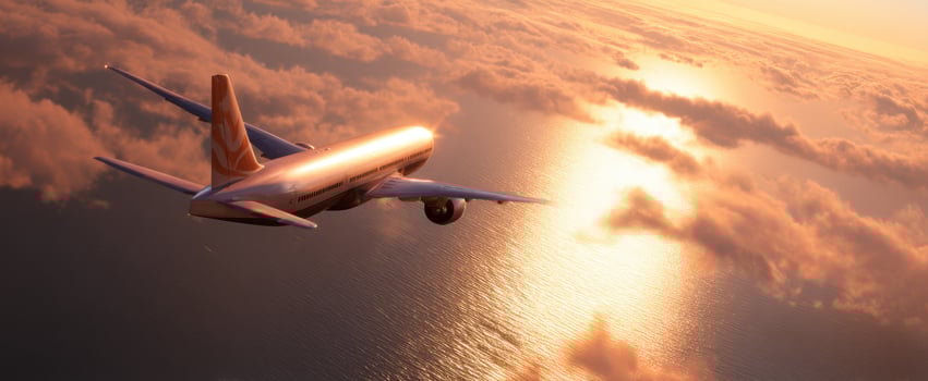 The soaring airplane gliding above clouds during a stunning sunset over the ocean. photo