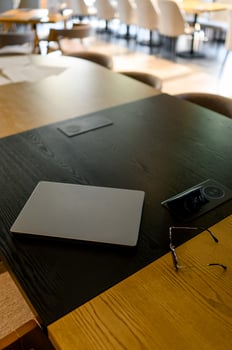 Laptop and glasses placed on a wooden table photo