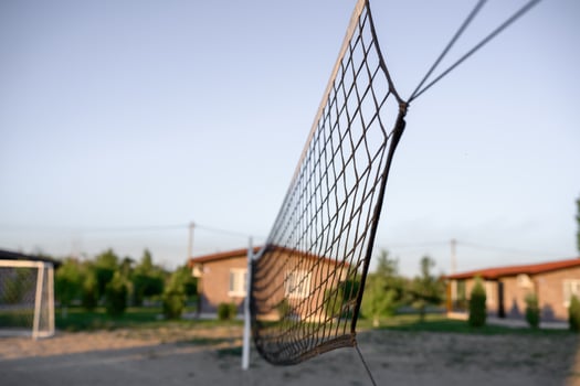 volleyball net stretched across a beach volleyball court photo