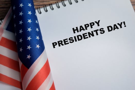 Concept of happy presidents day write on book and american flag isolated on Wooden Table. photo